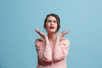 Image showing Beautiful woman in stress isolated on blue