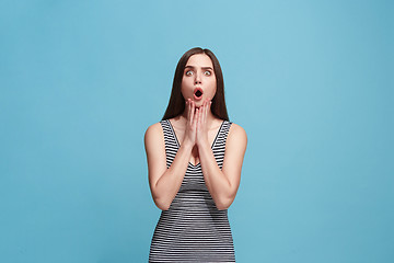 Image showing Beautiful woman looking suprised isolated on blue