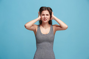 Image showing Woman having headache. Isolated over blue background.