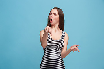 Image showing Portrait of an argue woman looking at camera isolated on a blue background