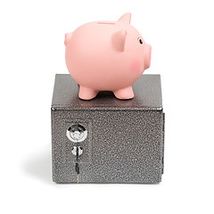 Image showing Piggy bank standing on a safe