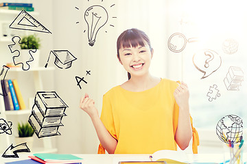 Image showing happy asian young woman student learning at home