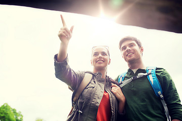 Image showing smiling couple with backpacks hiking