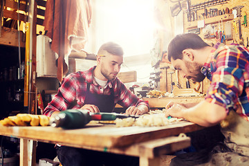 Image showing carpenters with ruler and blueprint at workshop