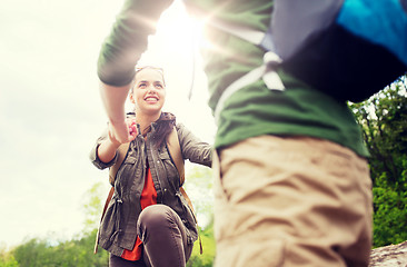 Image showing smiling couple with backpacks hiking