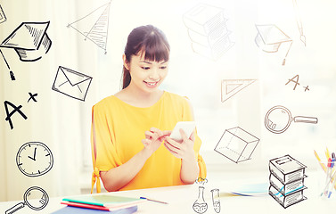 Image showing happy young woman student with smartphone at home