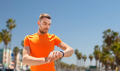 Image showing man with fitness tracker training outdoors