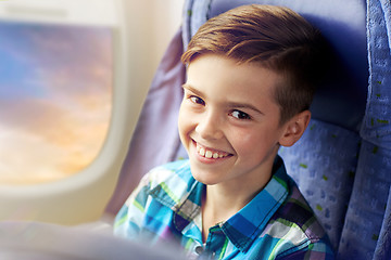 Image showing happy boy travelling by plane