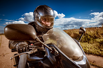 Image showing Biker racing on the road