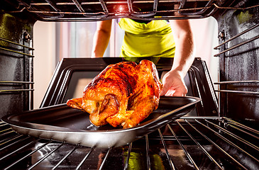 Image showing Cooking chicken in the oven at home.