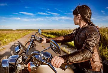 Image showing Biker girl sitting on motorcycle