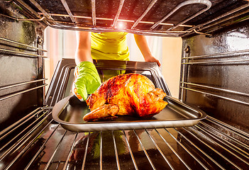 Image showing Cooking chicken in the oven at home.