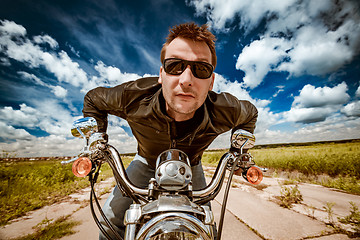 Image showing Biker racing on the road