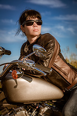 Image showing Biker girl sitting on motorcycle