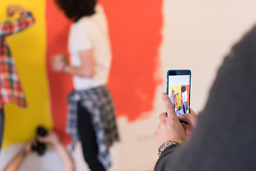 Image showing couple painting interior wall