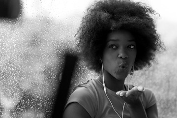 Image showing portrait of young afro american woman in gym while listening mus