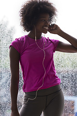 Image showing portrait of young afro american woman in gym while listening mus