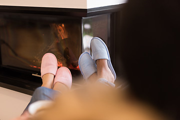 Image showing Young multiethnic couple  in front of fireplace