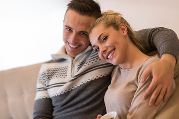 Image showing Young couple  in front of fireplace