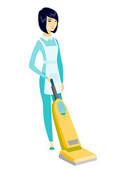 Image showing Cleaner cleaning floor with a vacuum cleaner.