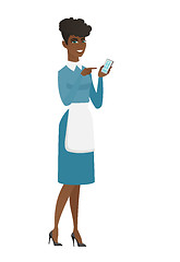 Image showing African cleaner holding a mobile phone.