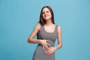 Image showing The happy business woman standing and smiling against blue background.