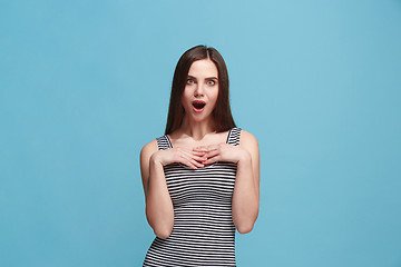 Image showing Beautiful woman looking suprised isolated on blue