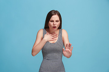 Image showing Young woman overwhelmed with a pain in the throat