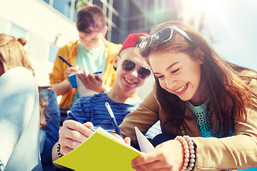 Image showing group of students with notebooks at school yard