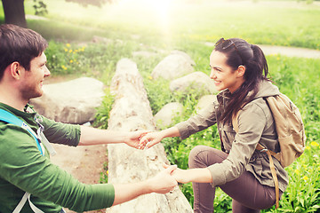 Image showing smiling couple with backpacks hiking