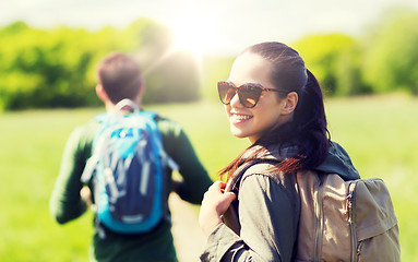 Image showing happy couple with backpacks hiking outdoors