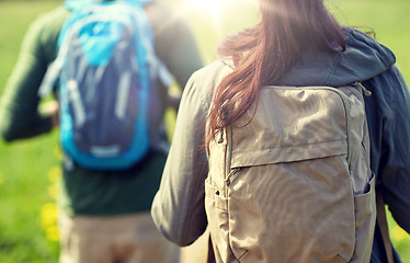 Image showing close up of couple with backpacks hiking outdoors