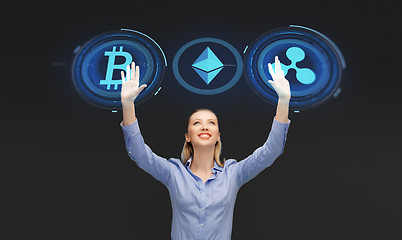 Image showing businesswoman with cryptocurrency holograms