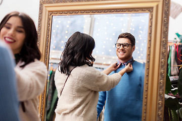 Image showing couple choosing clothes at vintage clothing store