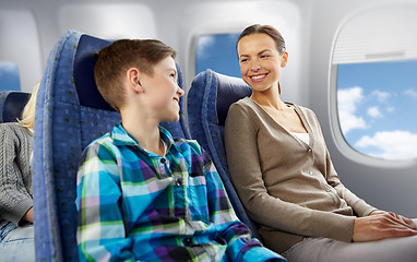 Image showing happy mother and son traveling by plane