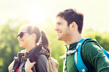 Image showing happy couple with backpacks hiking outdoors