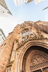 Image showing Wide angle upward view of Trinity Church at Broadway and Wall Street with surrounding skyscrapers, Lower Manhattan, New York City, USA