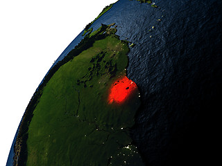 Image showing Suriname in red on Earth at night