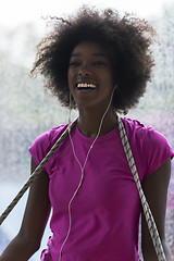 Image showing portrait of young afro american woman in gym while listening mus