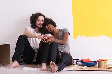 Image showing young multiethnic couple relaxing after painting