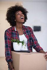 Image showing Black girl moving in the new apartment