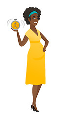 Image showing African pregnant woman holding alarm clock.