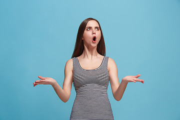 Image showing Portrait of an argue woman looking at camera isolated on a blue background