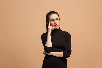 Image showing Young serious thoughtful business woman. Doubt concept.