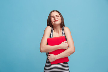 Image showing Businesswoman hugging laptop on blue studio