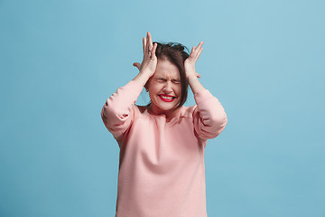 Image showing Beautiful woman in stress isolated on blue