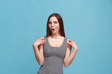 Image showing Beautiful woman looking suprised isolated on blue