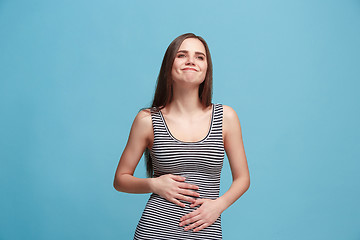 Image showing The happy business woman standing and smiling against blue background.