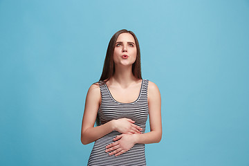 Image showing The happy business woman standing and smiling against blue background.