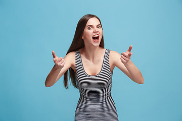 Image showing Portrait of an angry woman looking at camera isolated on a blue background